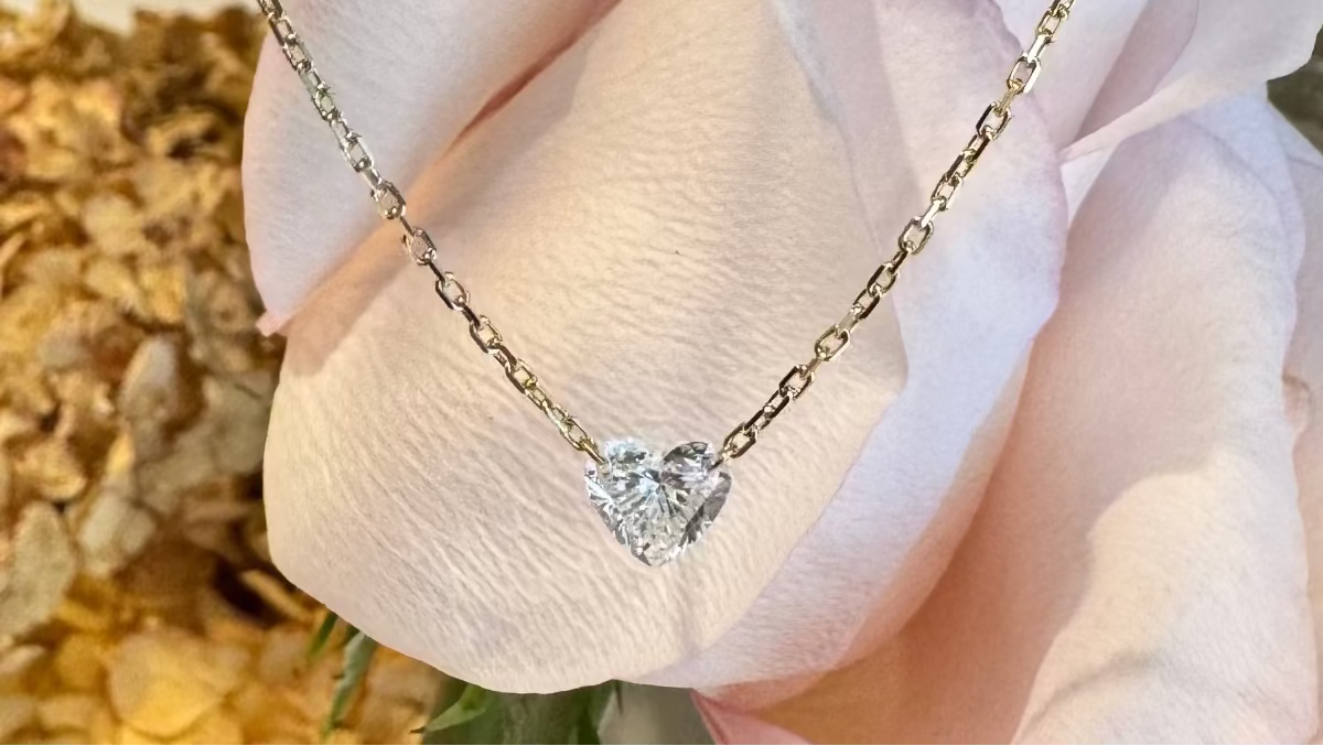 Floating heart necklace worn showing diamond detail