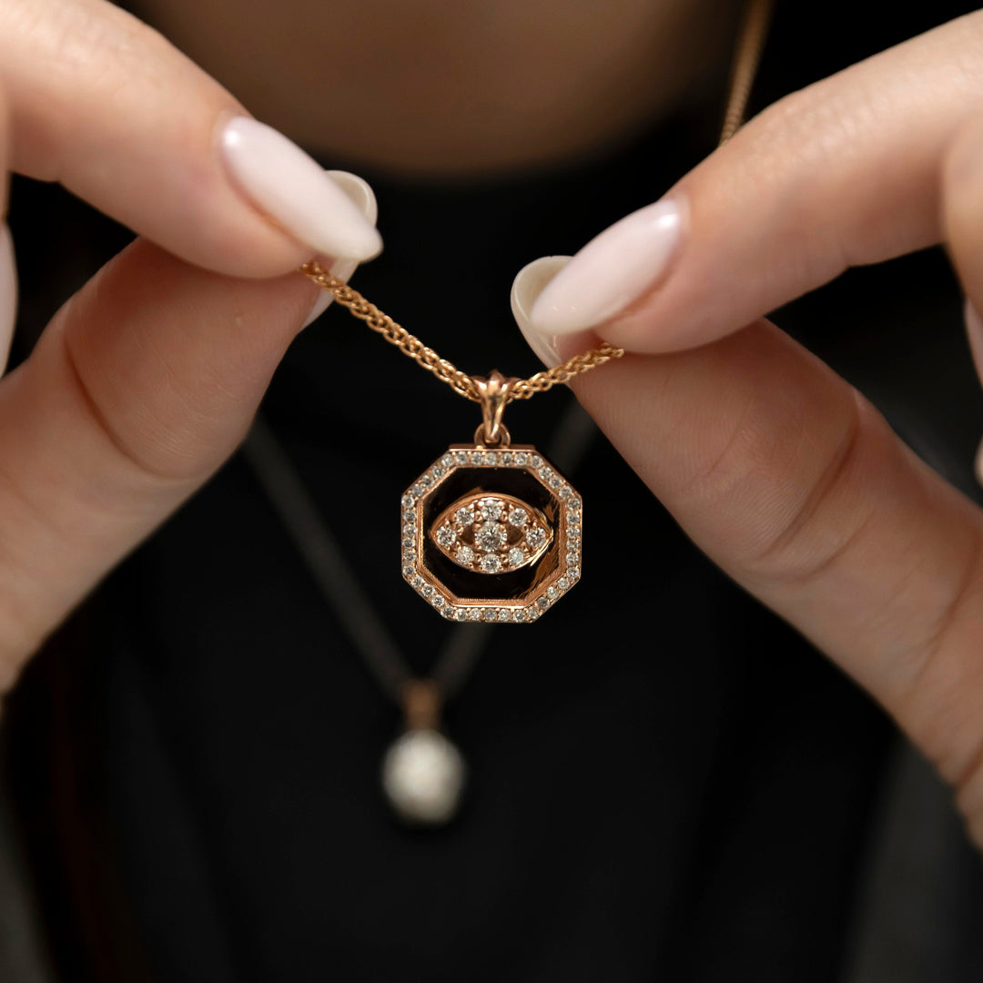 Ayin evil eye pendant worn on gold chain