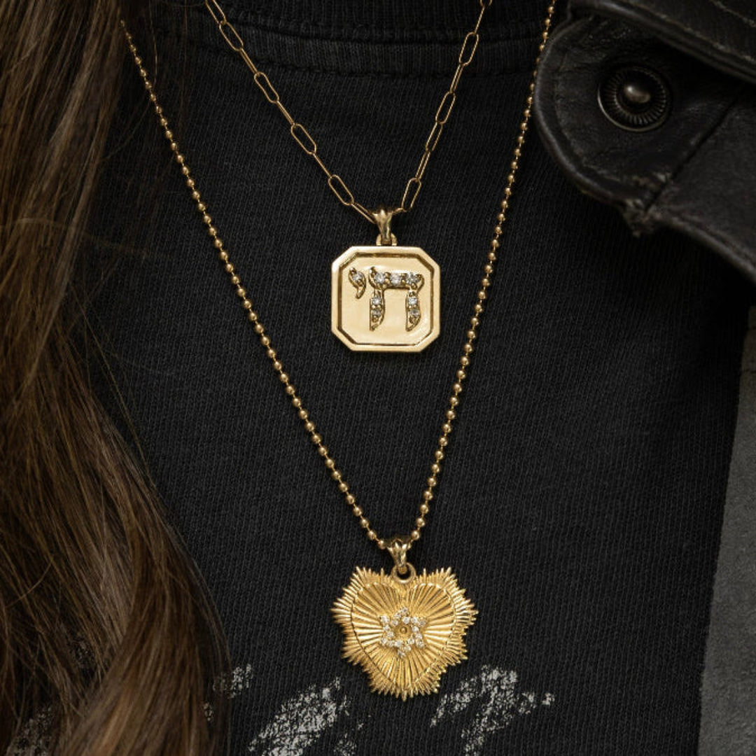 Sarah Chai pendant worn on gold chain necklace