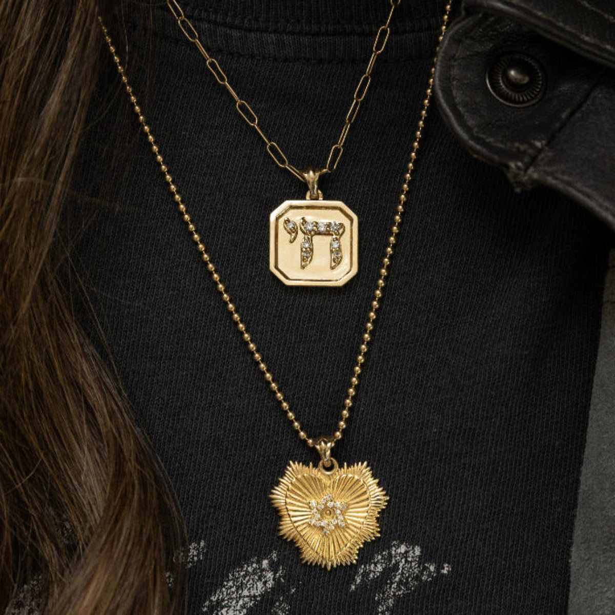 Sarah Chai pendant worn on gold chain necklace