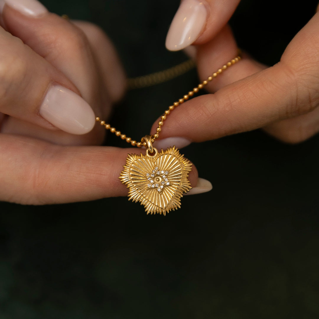 Lev pendant close-up showing diamond heart detail