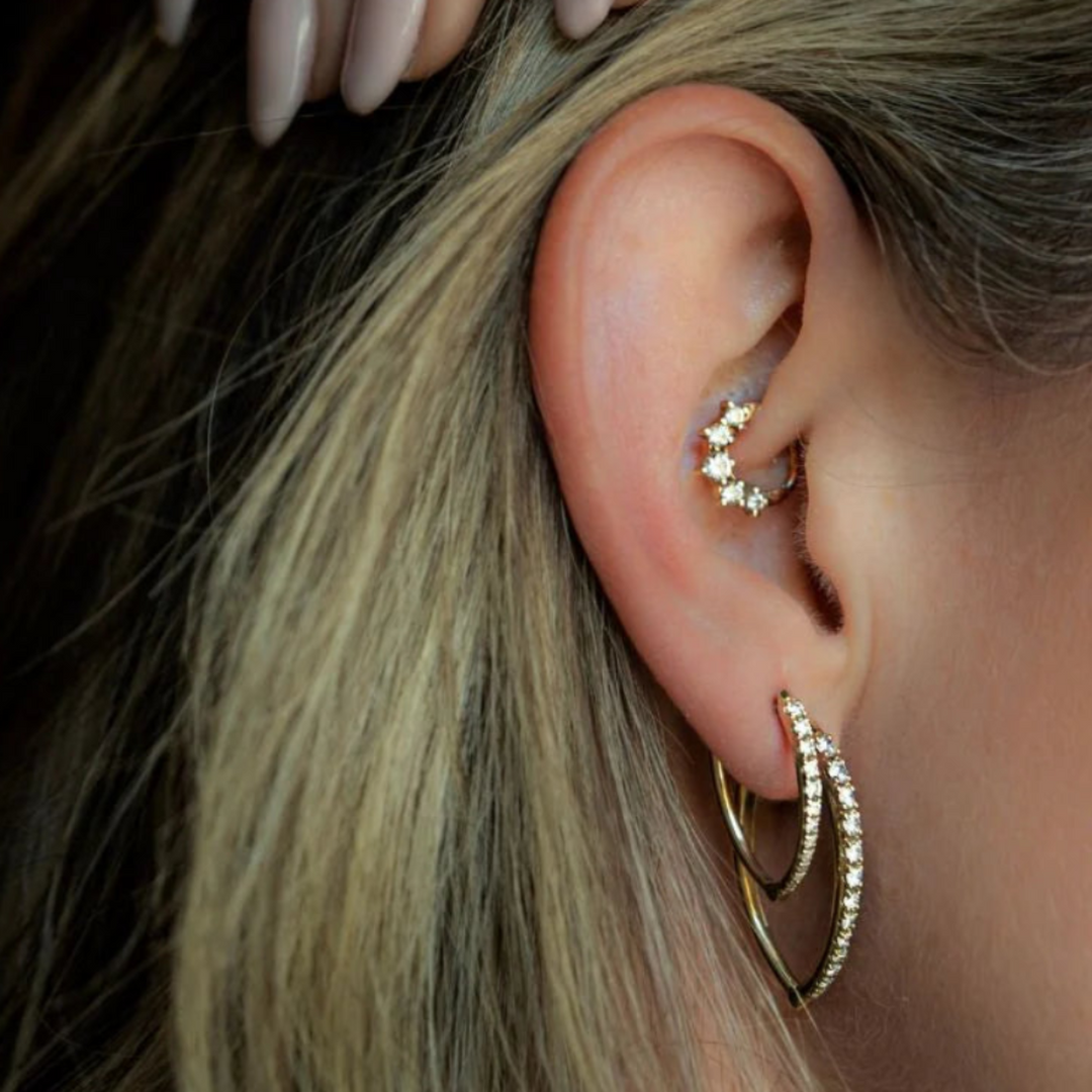 Gold diamond hoop earrings worn showing V shape profile